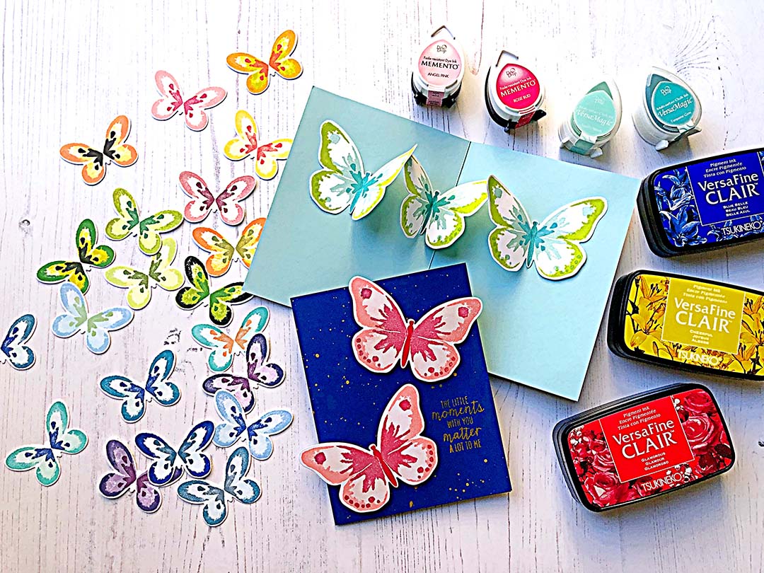 Handmade card featuring layered stamped butterflies that are arranged to create a pop up element inside the greeting card.